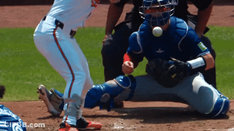 A Baseball Player Wearing A Blue Catcher 'S Helmet Is Getting Ready To Catch The Ball GIF
