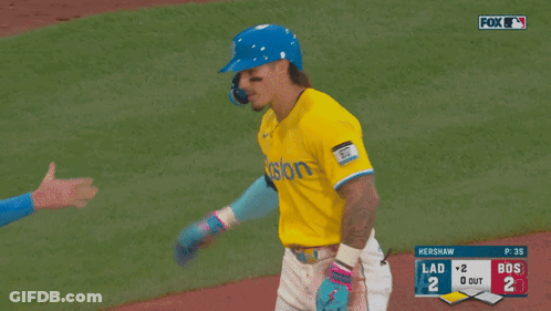 A Baseball Player Wearing A Blue Helmet And A Yellow Jersey With The Word Posto On It GIF