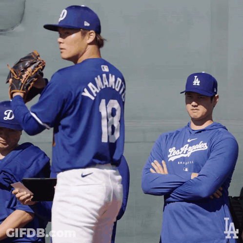 A Baseball Player Wearing A Blue Jersey With The Number 18 On It GIF