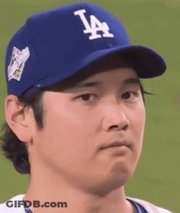 A Baseball Player Wearing A Blue La Hat Is Making A Face . GIF