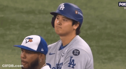A Baseball Player Wearing A Blue La Helmet Looks To The Side GIF