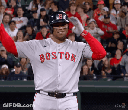 A Baseball Player Wearing A Boston Jersey Holds His Arms Up In The Air GIF