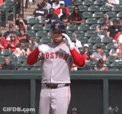 A Baseball Player Wearing A Boston Jersey Holds His Helmet Up GIF