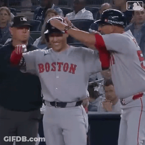 A Baseball Player Wearing A Boston Jersey Is Being Congratulated By Another Player GIF