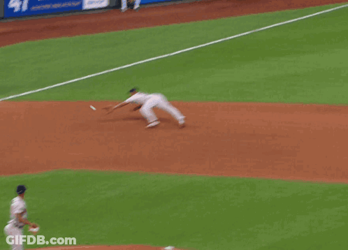 A Baseball Player Wearing A Boston Jersey Is Kneeling Down To Catch A Ball GIF
