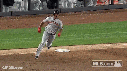 A Baseball Player Wearing A Boston Jersey Is Running To Base GIF