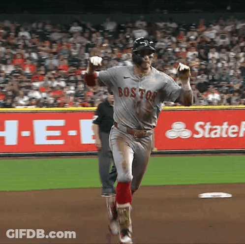 A Baseball Player Wearing A Boston Jersey Is Running Towards The Base GIF