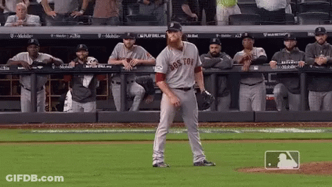 A Baseball Player Wearing A Boston Jersey Stands On A Field GIF