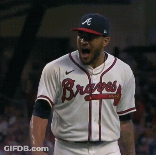 A Baseball Player Wearing A Braves Jersey And Hat GIF