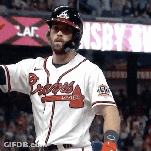 A Baseball Player Wearing A Braves Jersey Is Standing In Front Of A Sign GIF
