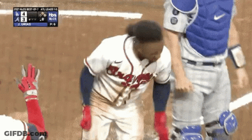A Baseball Player Wearing A Braves Jersey Is Standing On A Baseball Field GIF