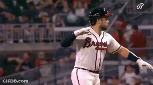 A Baseball Player Wearing A Braves Jersey Is Standing On The Field GIF
