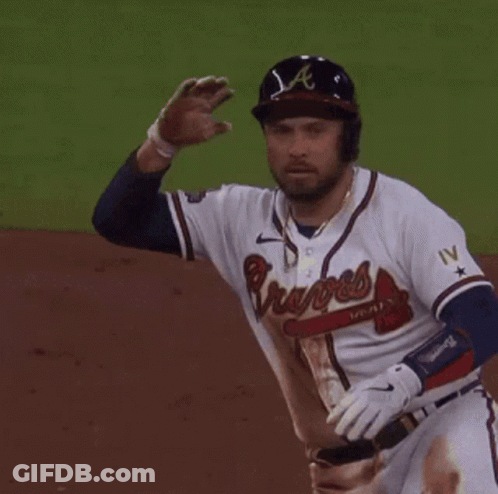 A Baseball Player Wearing A Braves Jersey Is Waving GIF