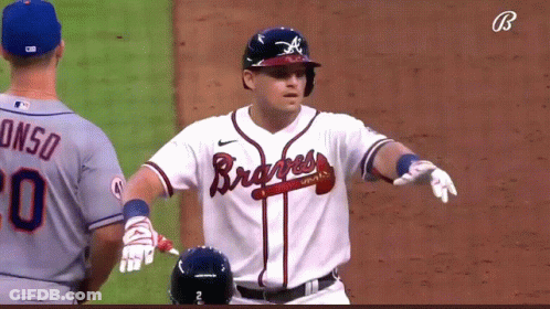 A Baseball Player Wearing A Braves Jersey Stands On The Field GIF