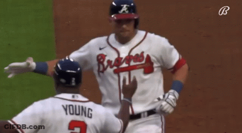 A Baseball Player Wearing A Braves Jersey Talks To Another Player GIF