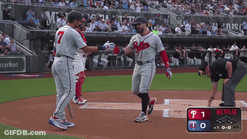 A Baseball Player Wearing A Braves Uniform Is Congratulating Another Player GIF