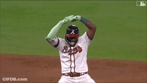 A Baseball Player Wearing A Braves Uniform Is Kneeling On The Field GIF