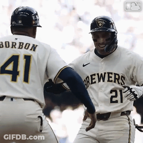 A Baseball Player Wearing A Brewers Jersey Is Congratulating Another Player GIF