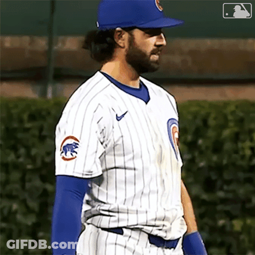 A Baseball Player Wearing A Chicago Cubs Uniform Is Standing On The Field GIF