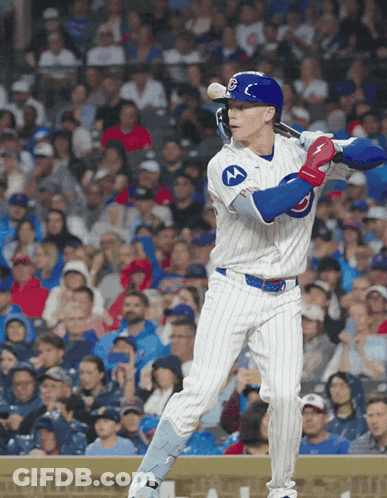 A Baseball Player Wearing A Chicago Cubs Uniform Swings His Bat GIF