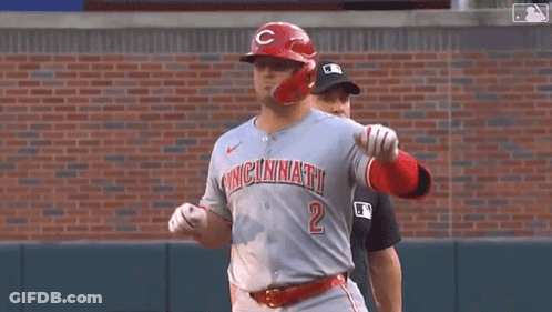 A Baseball Player Wearing A Cincinnati Jersey Is Standing On A Baseball Field . GIF