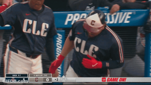 A Baseball Player Wearing A Cle Jersey Stands In Front Of A Dugout GIF