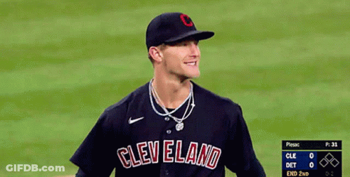A Baseball Player Wearing A Cleveland Jersey Smiles On The Field GIF