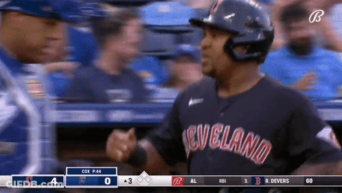 A Baseball Player Wearing A Cleveland Uniform Shakes Hands With Another Player GIF