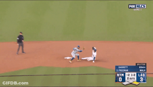 A Baseball Player Wearing A Dodgers Jersey Is Laying On The Ground GIF