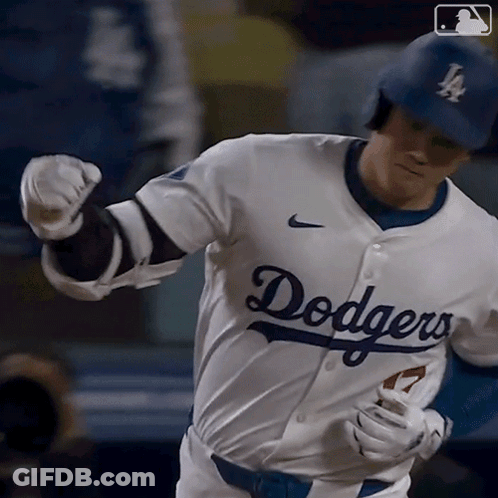 A Baseball Player Wearing A Dodgers Jersey Runs Towards Home Plate GIF