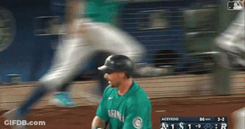 A Baseball Player Wearing A Green Seahawks Jersey GIF