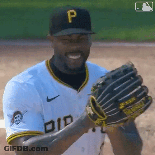 A Baseball Player Wearing A Hat With The Letter P On It Is Smiling And Holding A Glove . GIF