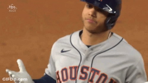 A Baseball Player Wearing A Helmet And A Houston Jersey Is Standing On A Field . GIF