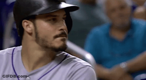 A Baseball Player Wearing A Helmet And A Purple Jersey GIF
