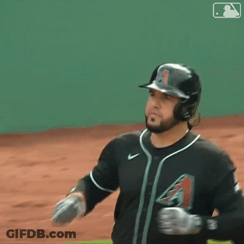 A Baseball Player Wearing A Helmet And Gloves Stands On A Field GIF