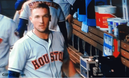 A Baseball Player Wearing A Houston Jersey Stands In The Dugout GIF