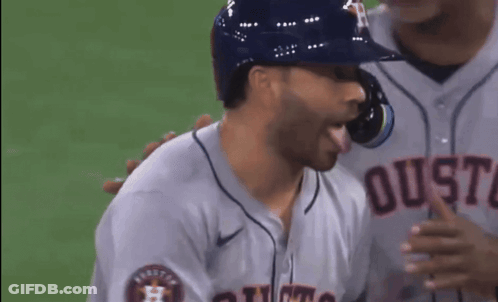 A Baseball Player Wearing A Jersey That Says Houston On The Front GIF