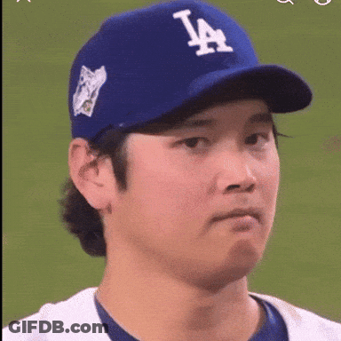 A Baseball Player Wearing A La Hat Makes A Face GIF