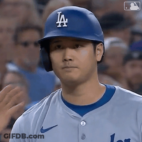A Baseball Player Wearing A La Helmet And Jersey GIF