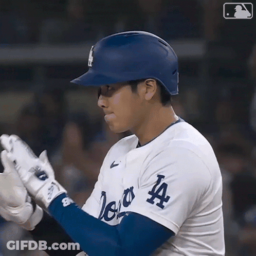 A Baseball Player Wearing A La Jersey Holds His Gloves Up GIF