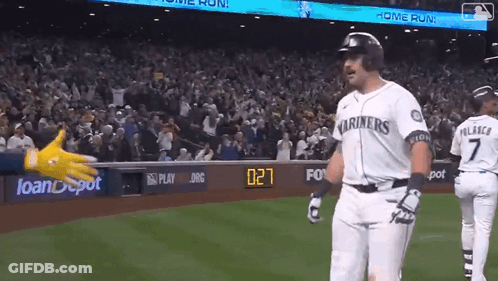 A Baseball Player Wearing A Mariners Jersey Is Standing On The Field GIF