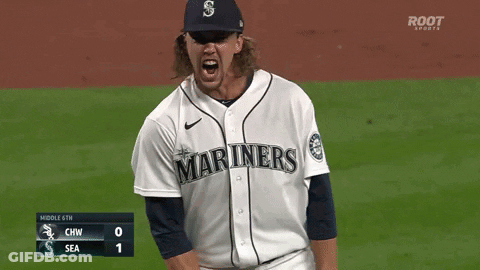 A Baseball Player Wearing A Mariners Jersey Stands On The Field GIF