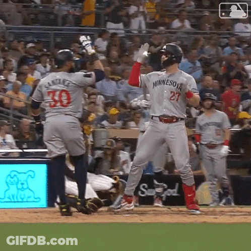 A Baseball Player Wearing A Minnesota Jersey Stands On The Field GIF