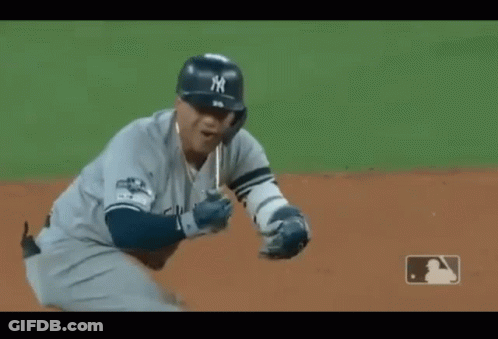 A Baseball Player Wearing A New York Jersey Is Standing On The Field GIF