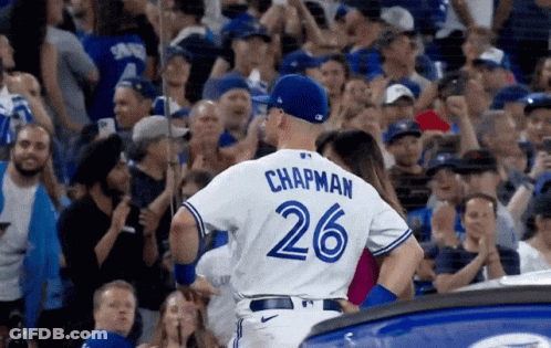 A Baseball Player Wearing A Number 26 Jersey Stands In Front Of A Crowd GIF
