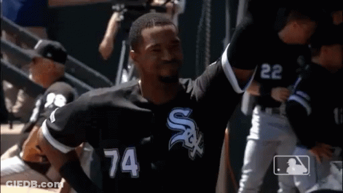 A Baseball Player Wearing A Number 74 Jersey Is Standing On The Field . GIF