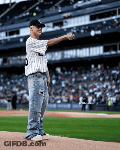 A Baseball Player Wearing A Number 9 Jersey Throws A Ball GIF