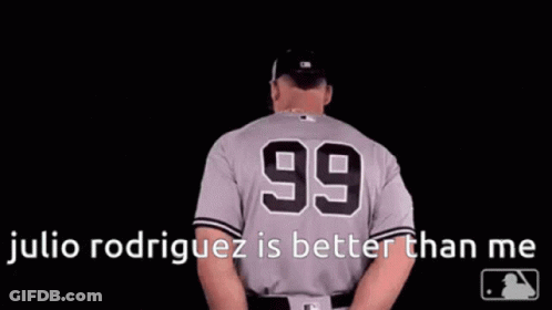 A Baseball Player Wearing A Number 99 Jersey Is Standing In The Dark . GIF