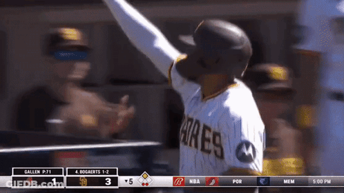 A Baseball Player Wearing A Padres Jersey Holds Up His Arm GIF