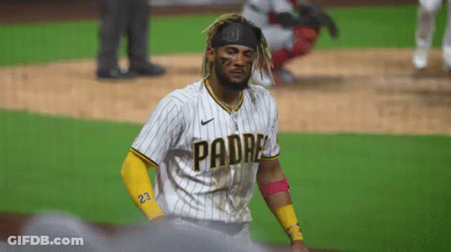 A Baseball Player Wearing A Padres Jersey Is Standing On A Field . GIF
